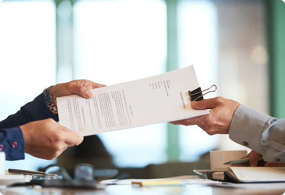 Person handing over a printed document for translation